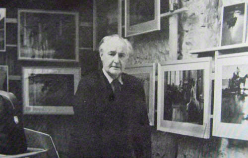 A picture showing Claude Buckle with current exhibition in his studio in 1972