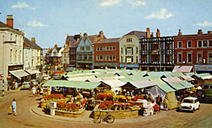 The Bull Ring Grimsby in the 1960s with its canopied market stalls and bright flower beds